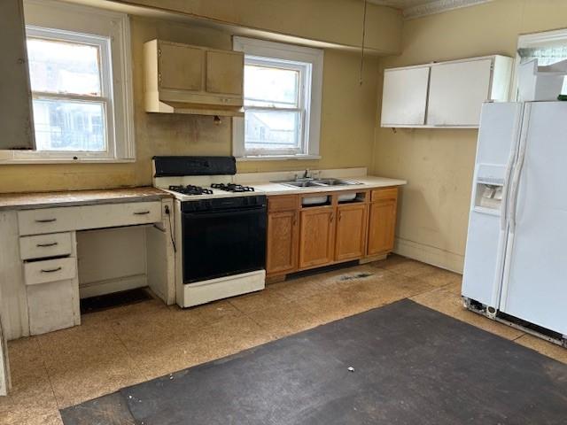 kitchen with sink, white appliances, custom exhaust hood, and white cabinets