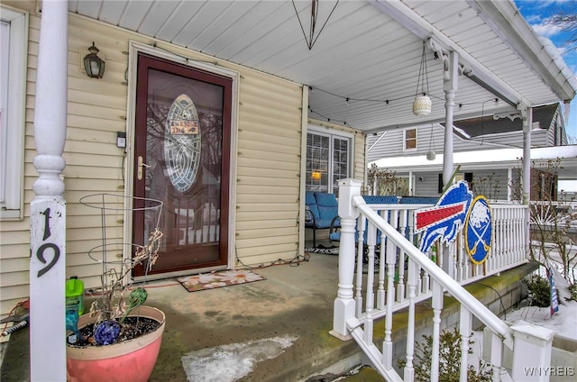 view of exterior entry with a porch