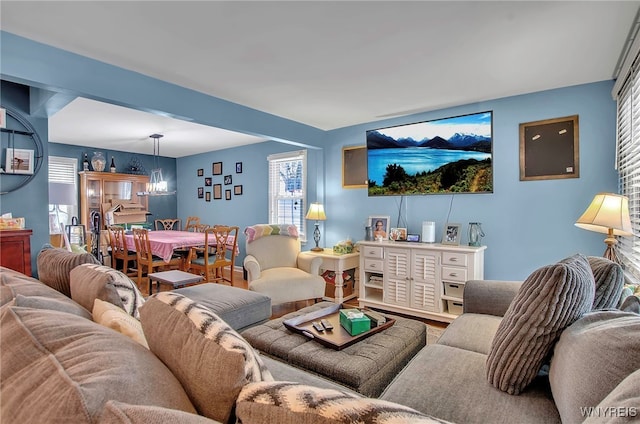 living room featuring hardwood / wood-style flooring and a notable chandelier