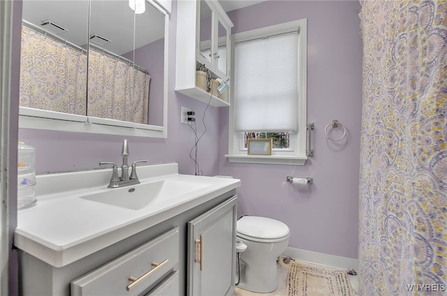 bathroom featuring vanity and toilet