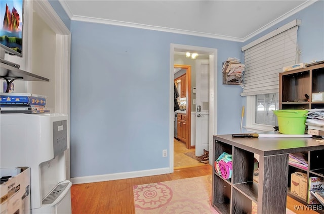 office space with ornamental molding and light hardwood / wood-style flooring