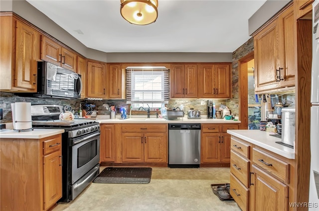 kitchen with tasteful backsplash, sink, and stainless steel appliances