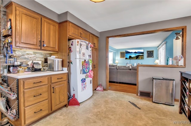 kitchen featuring tasteful backsplash and white fridge