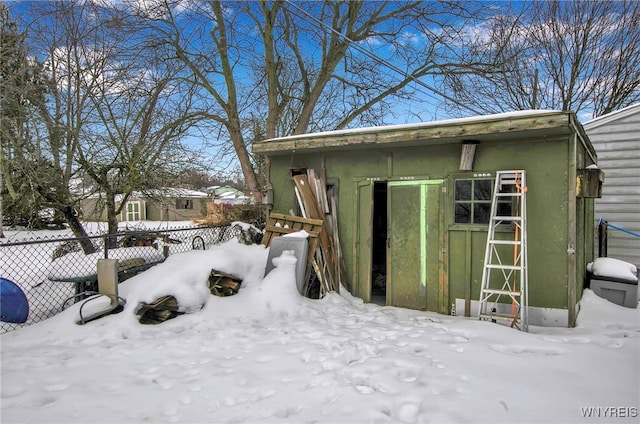 view of snowy exterior with an outdoor structure