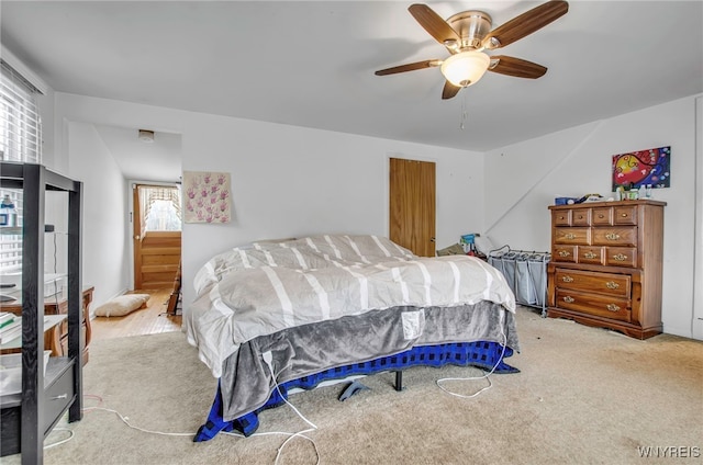 bedroom with light colored carpet and ceiling fan