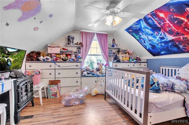 bedroom featuring vaulted ceiling, ceiling fan, and light wood-type flooring