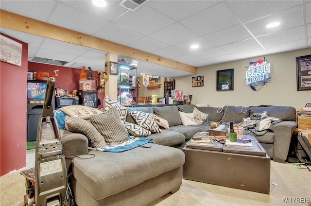 living room featuring a drop ceiling