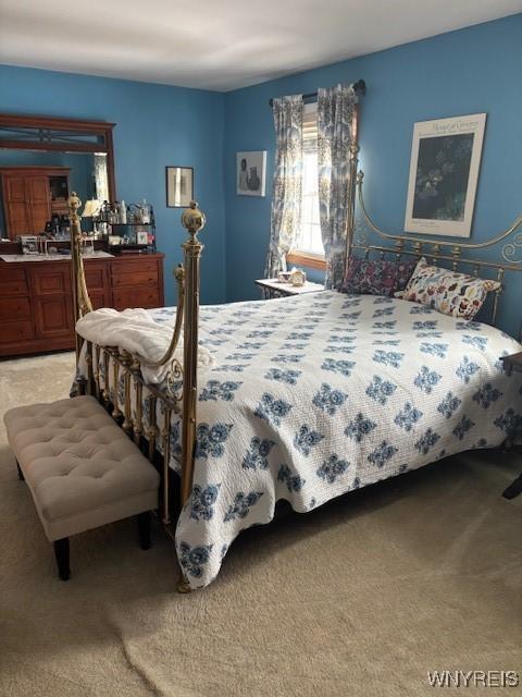 bedroom with light colored carpet