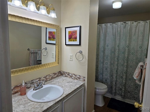 bathroom with vanity, toilet, and walk in shower