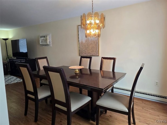 dining room with hardwood / wood-style flooring, a chandelier, and baseboard heating