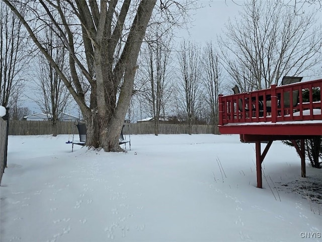 yard covered in snow featuring a wooden deck