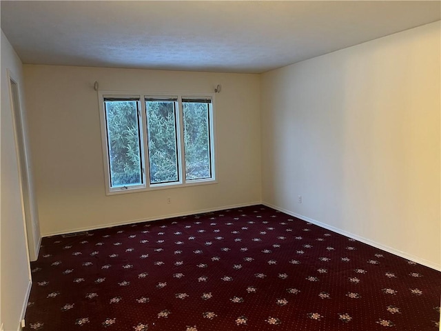 empty room with dark carpet