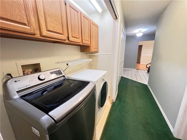 laundry room featuring cabinets, dark carpet, and washer and dryer