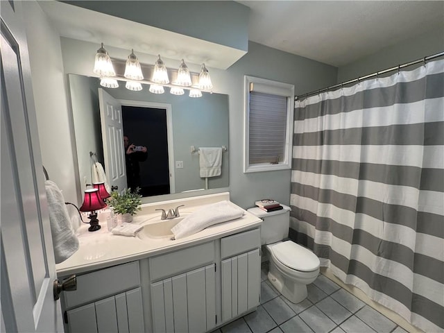 bathroom featuring vanity, toilet, and tile patterned flooring