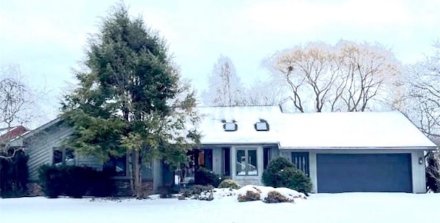 ranch-style home featuring a garage