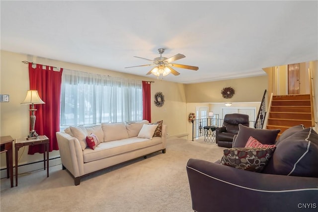 living room featuring a baseboard heating unit, ceiling fan, and carpet