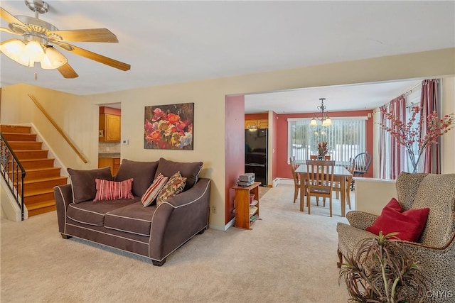 living room featuring ceiling fan, a baseboard radiator, and light carpet