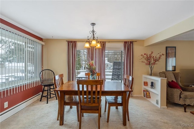 carpeted dining room with an inviting chandelier, a wealth of natural light, and a baseboard radiator