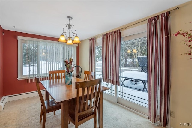 dining room featuring baseboard heating, light carpet, and a notable chandelier