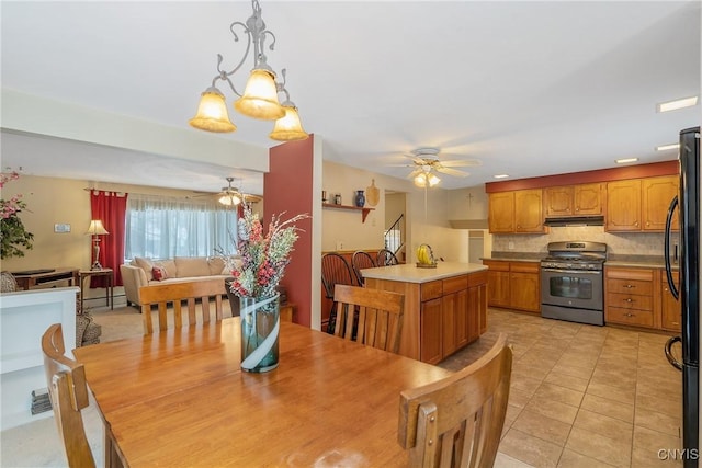 tiled dining space with ceiling fan and baseboard heating