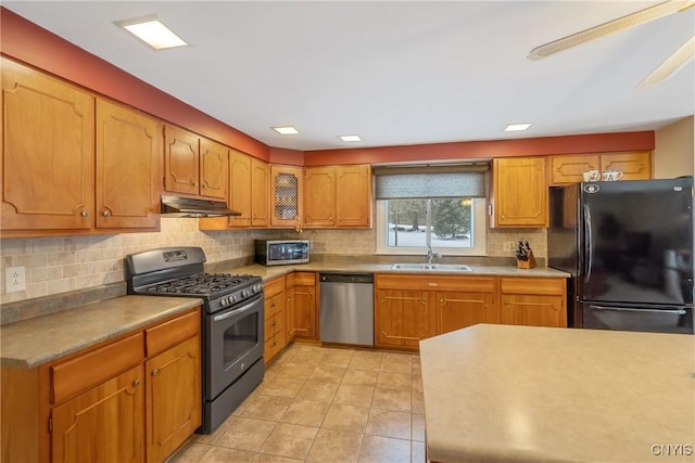 kitchen with stainless steel appliances, sink, decorative backsplash, and light tile patterned floors