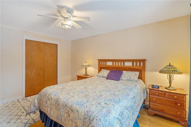 bedroom with ceiling fan, a closet, and light hardwood / wood-style flooring