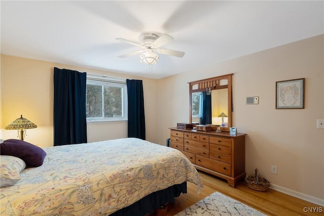 bedroom with light hardwood / wood-style flooring and ceiling fan