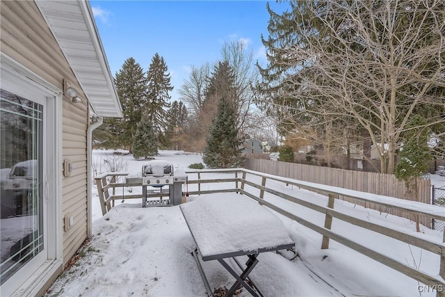 snow covered patio featuring a grill