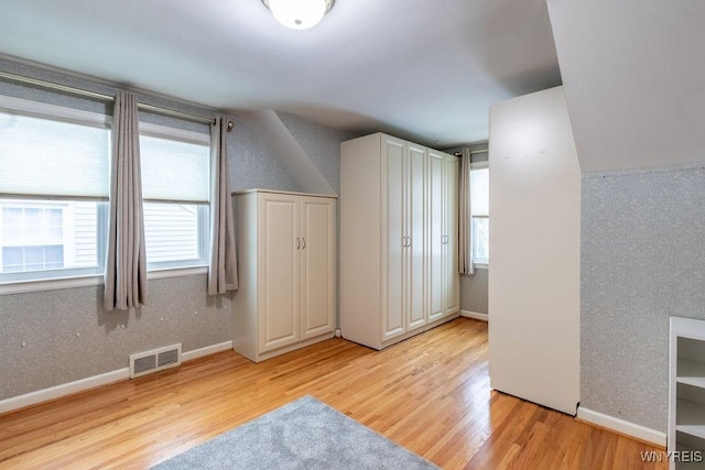 additional living space featuring light hardwood / wood-style flooring