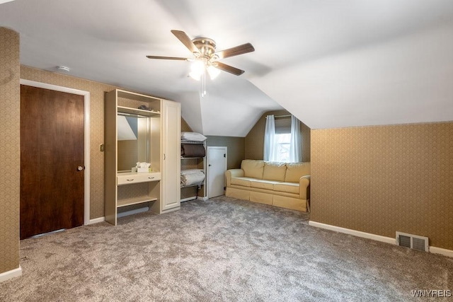 additional living space featuring vaulted ceiling, carpet floors, and ceiling fan