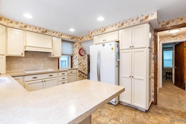 kitchen featuring light carpet, sink, and white appliances