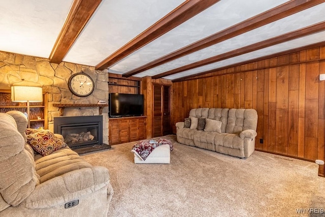 living room featuring beamed ceiling, carpet, and wood walls