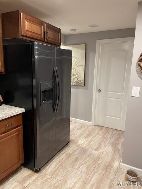 kitchen featuring stainless steel fridge with ice dispenser