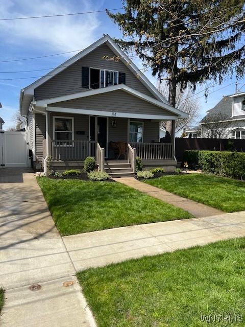 bungalow-style house with a porch and a front yard