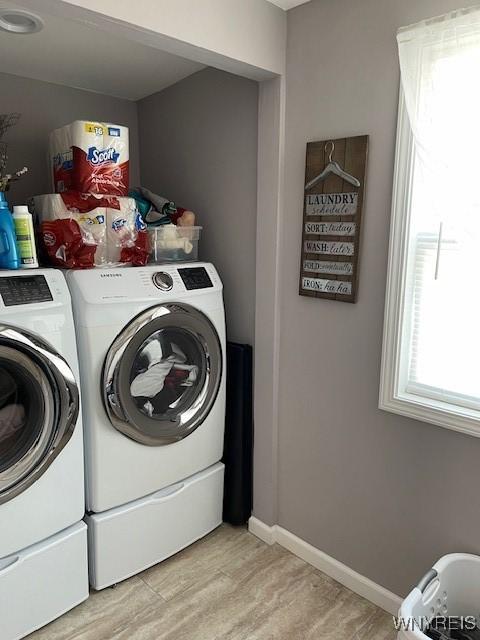 laundry area featuring washer and dryer and light wood-type flooring