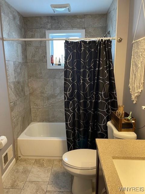 full bathroom featuring vanity, tile patterned flooring, toilet, and shower / bath combo