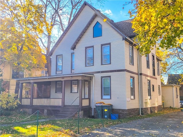 rear view of property with a porch