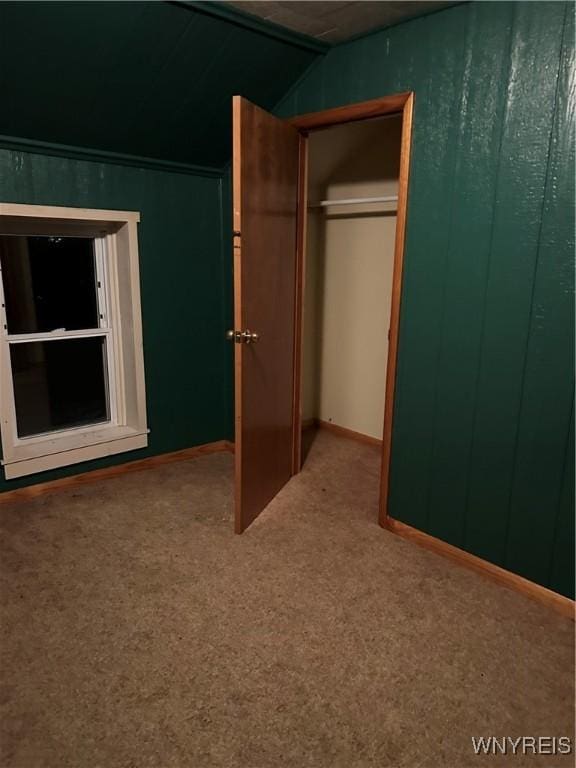 unfurnished bedroom featuring carpet and a closet