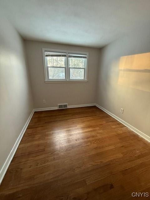 spare room with dark hardwood / wood-style floors