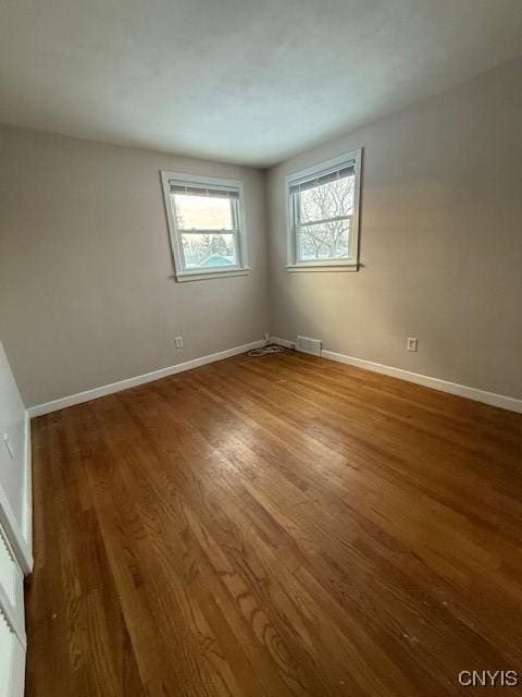 empty room with hardwood / wood-style flooring