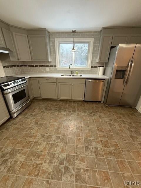 kitchen with gray cabinets, appliances with stainless steel finishes, sink, and backsplash