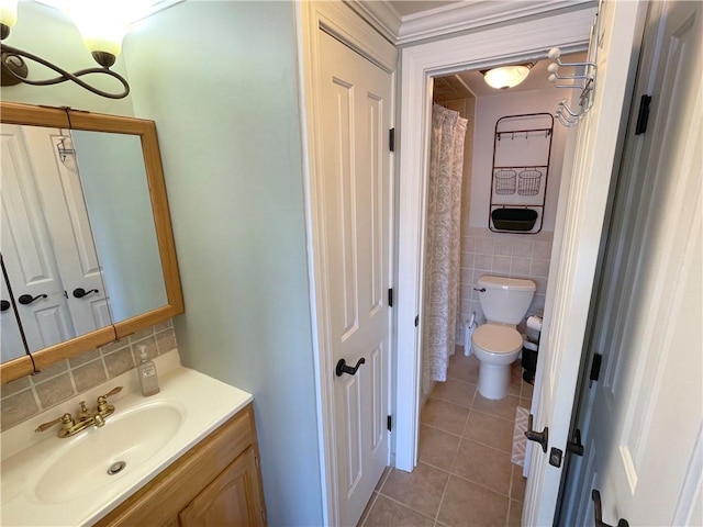 bathroom featuring tile walls, vanity, tasteful backsplash, tile patterned floors, and toilet