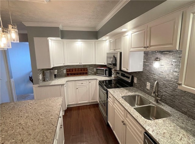 kitchen with dark hardwood / wood-style floors, white cabinetry, sink, hanging light fixtures, and stainless steel appliances