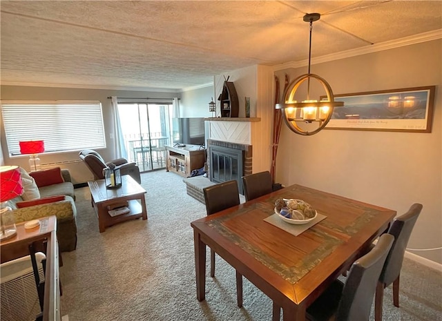 dining space featuring crown molding, carpet flooring, a chandelier, and a brick fireplace