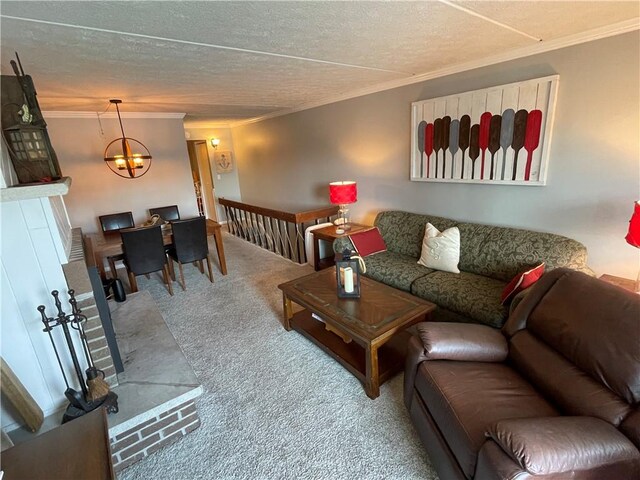 living room with an inviting chandelier, ornamental molding, a textured ceiling, and carpet