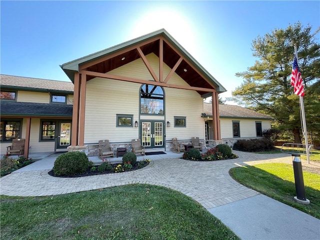 view of front of property with a front yard and french doors