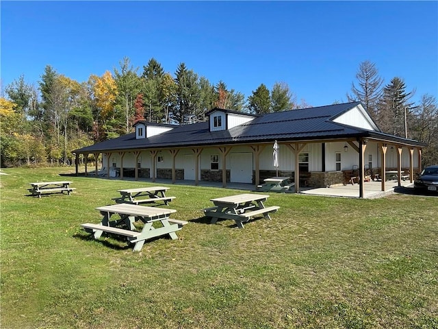 rear view of property with a lawn and a patio area