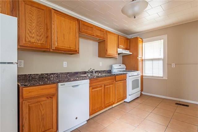 kitchen with crown molding, sink, white appliances, and dark stone counters