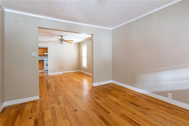 unfurnished living room featuring crown molding, ceiling fan, and light wood-type flooring