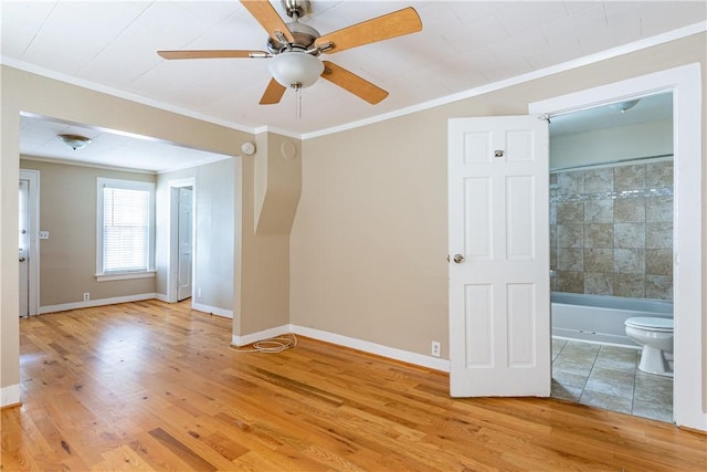 spare room featuring ornamental molding, ceiling fan, and light wood-type flooring